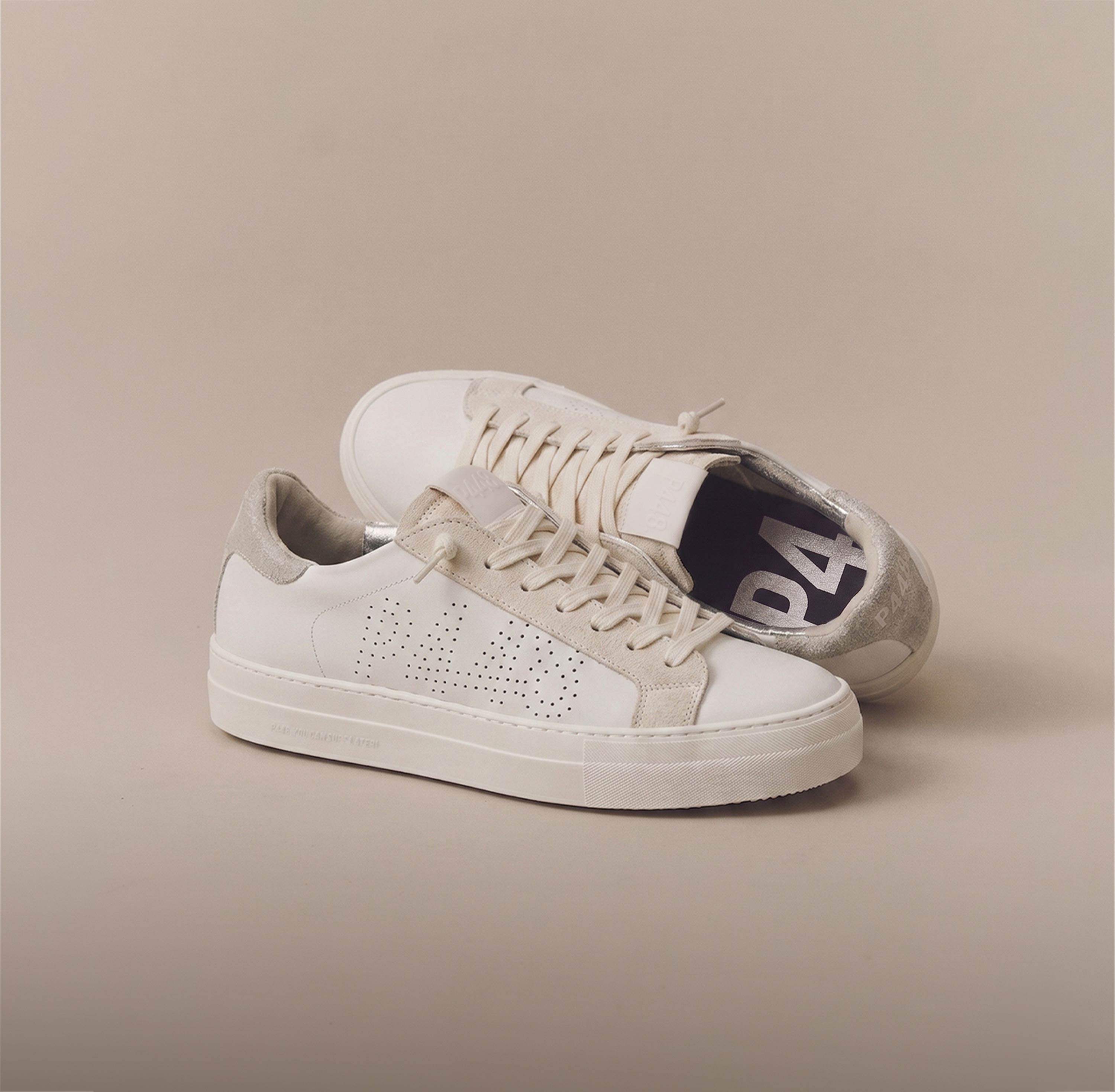 P448 women's sneaker in white leather with a perforated logo, beige suede details, and a metallic silver heel tab.