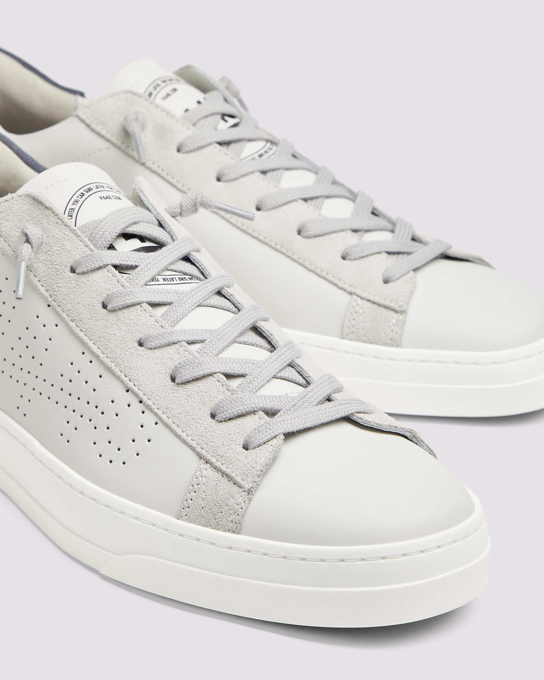 Side angle of white and blue sneakers