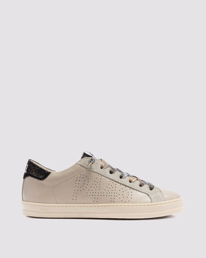 Side angle of beige and black sneakers