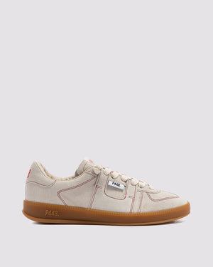 Side angle of beige with burgundy stitch sneakers