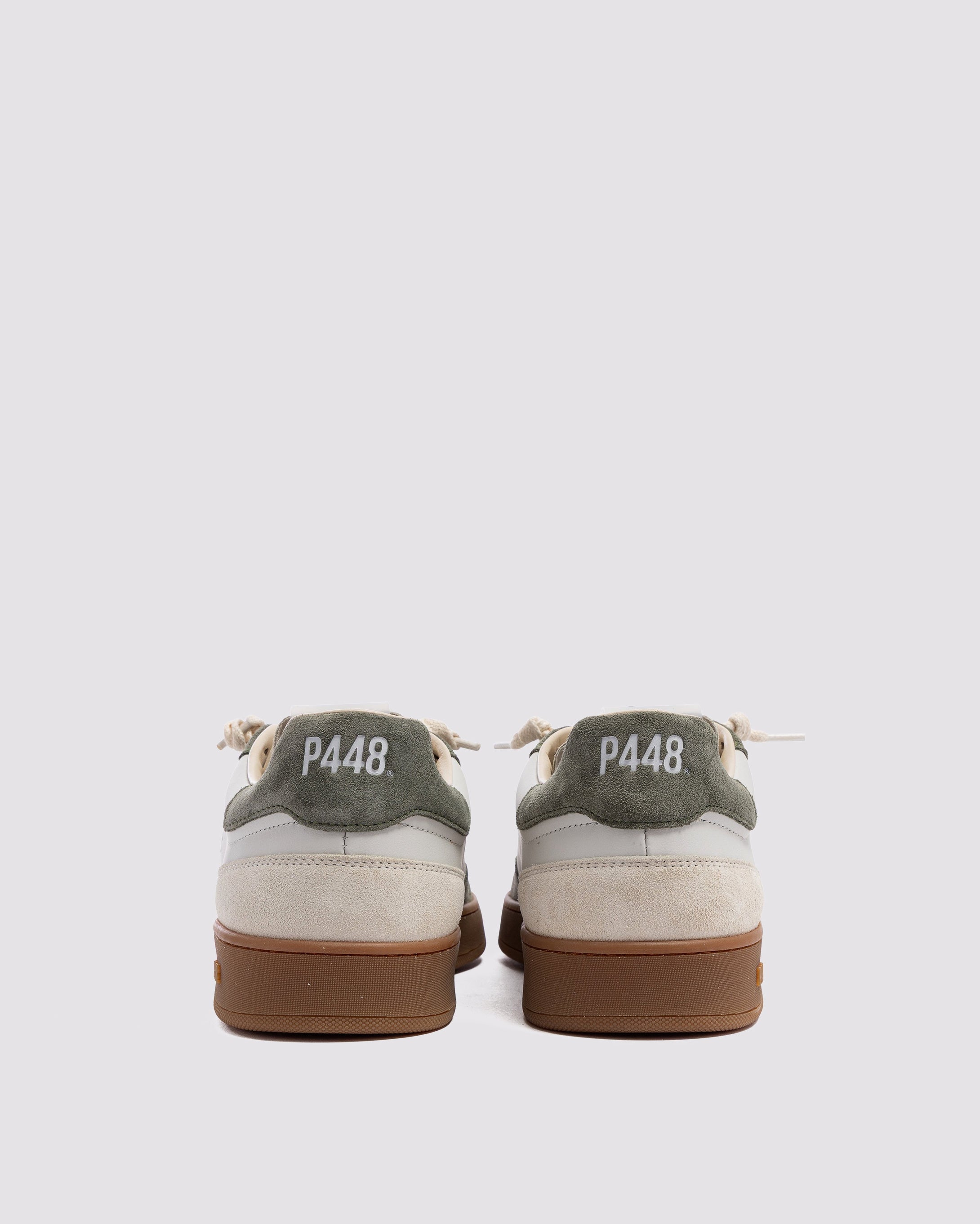 Side angle of white and green sneakers