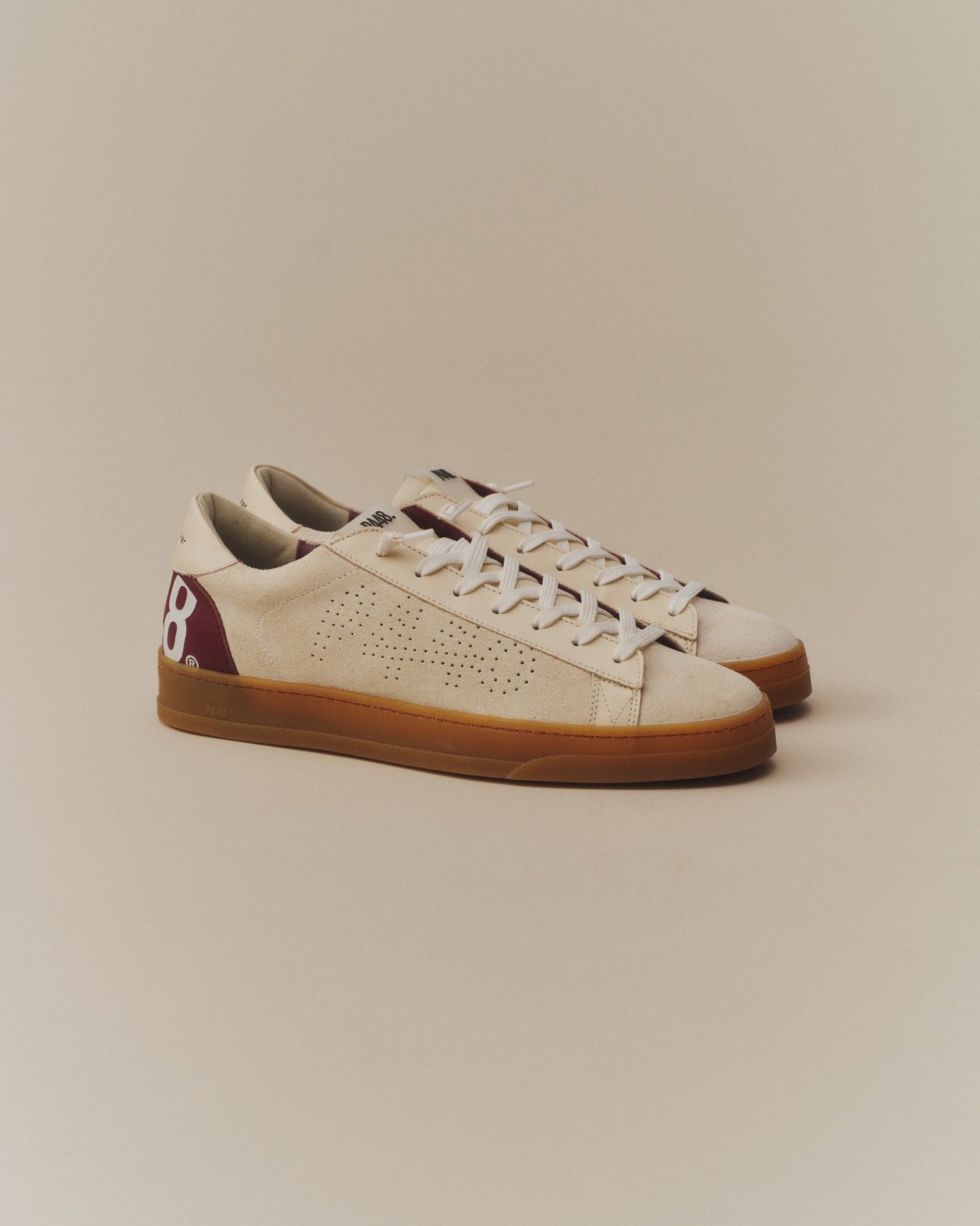 Side angle ofbeige with burgundy laces sneakers