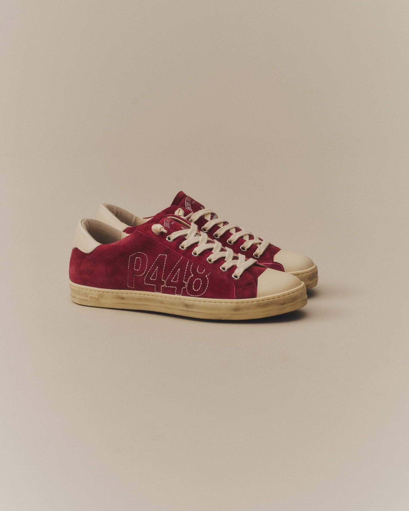 Side angle of burgundy sneakers